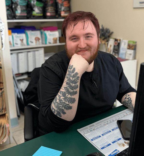Brandon behind the desk smiling