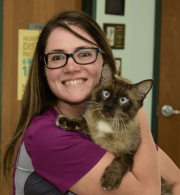 Melissa holding a Siamese cat