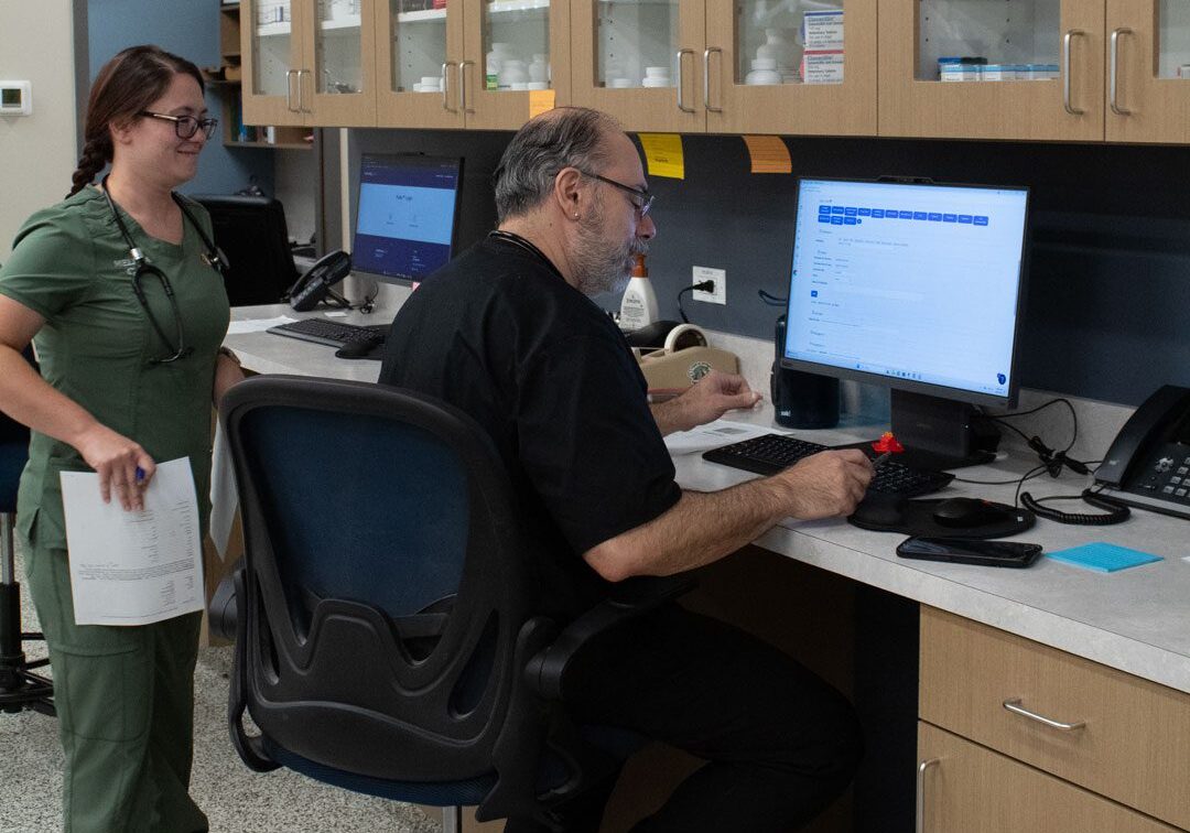 male veterinarian using a computer